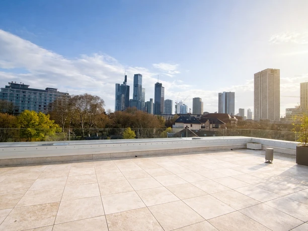 The Suite Garden Hotel - Roof terrace Empty rooftop terrace with glass railing and skyline