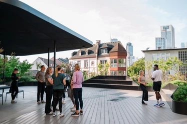 WESTEND TOWER Rooms and Roofs - Roof terrace Group on rooftop terrace overlooking Frankfurt skyline
