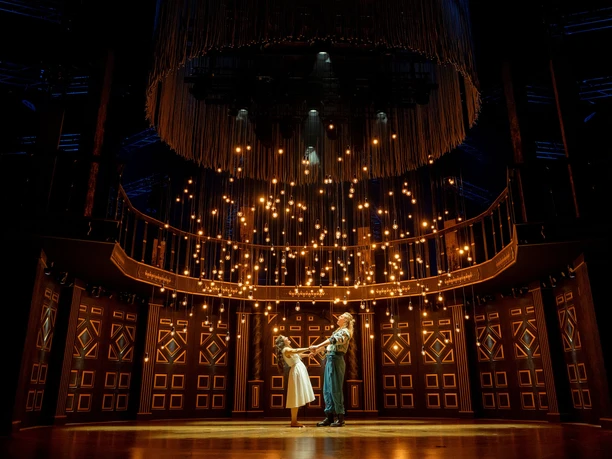 ROMEO & JULIA – LIEBE IST ALLES Zwei Darsteller unter funkelnden Lichtern auf einer prachtvollen Bühne des Musiktheaters