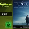 Filmplakat La Grazia: Mann im Mantel und Hut auf Feld unter blauem Himmel