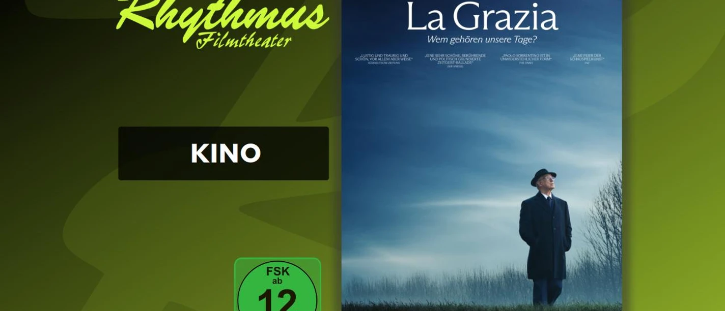 filmplakat-lagrazia.jpg Filmplakat La Grazia: Mann im Mantel und Hut auf Feld unter blauem Himmel