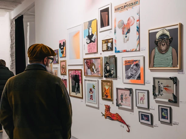 Urban Wildcard Art at Studio 40 Cologne Person looking at a wall with various works of art in a bright gallery