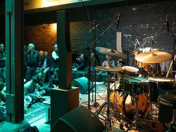 Frankfurt Milchsackfabrik Drum kit on stage, audience in background