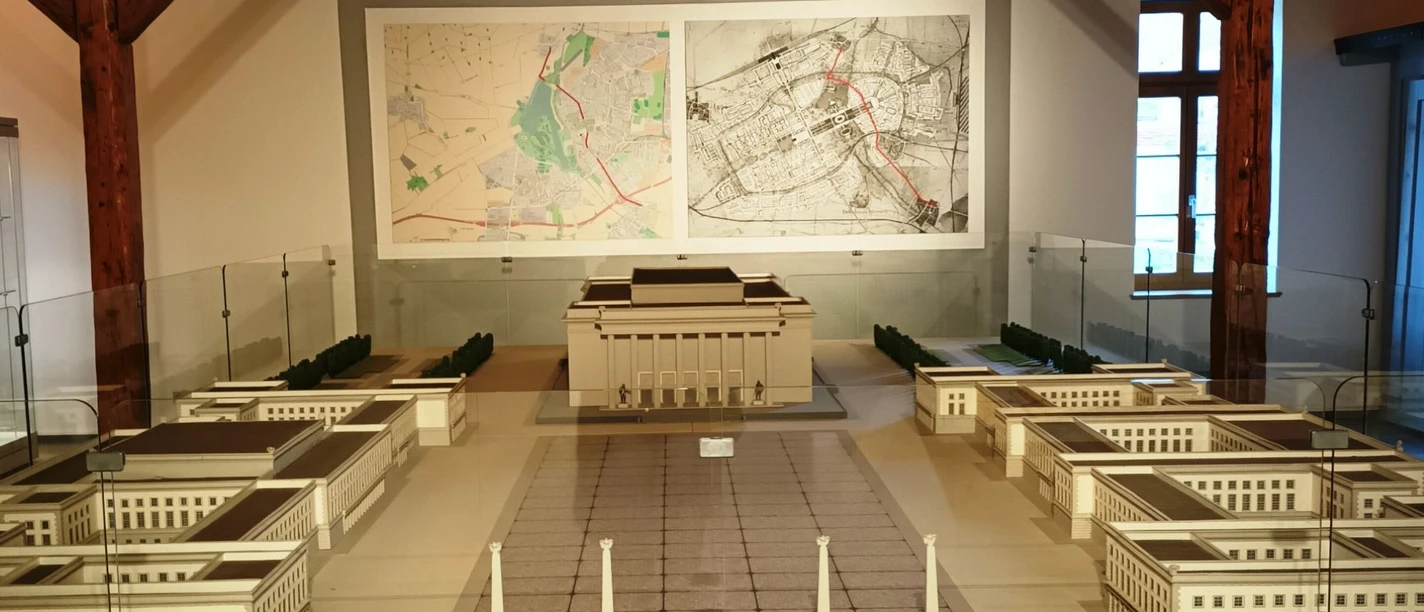 Ausstellung_Neuzeit_Salder_HD_16zu9.jpg Architekturmodell der Stadt Salzgitter vor großen Bauplänen im Museum.