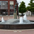 Klesmerbrunnen_HD_16zu9.JPG Runder Klesmerbrunnen in Salzgitter mit Wasserfontänen und Skulpturen von Wandermusikanten auf einem Platz.