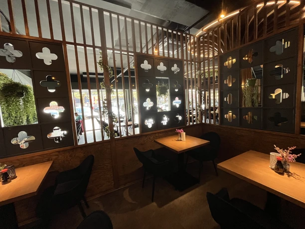 Natsu Modernes japanisches Restaurant mit Holzwänden, kleinen Tischen und warmem Licht