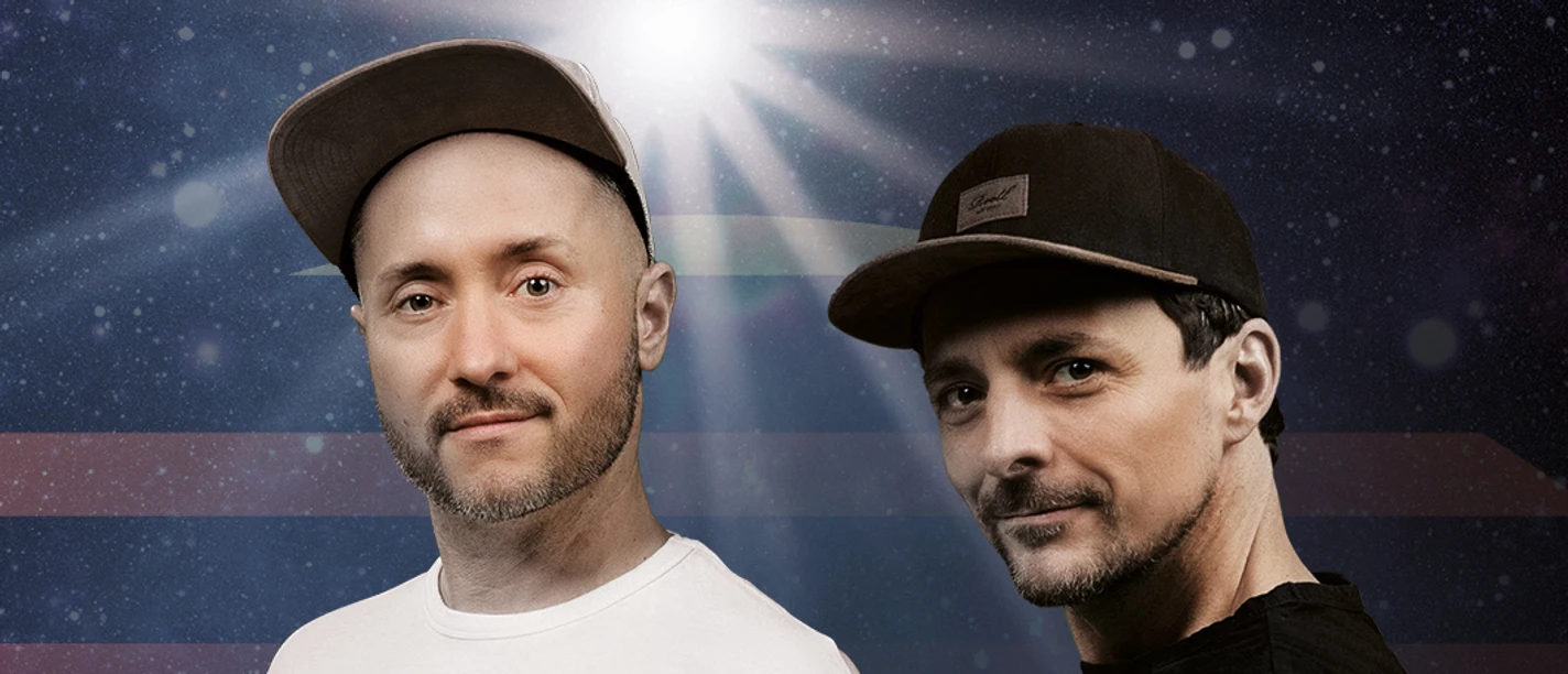 Cris Cosmo and Michl Fischer Two men with caps in front of a dark, cosmic background with rays of light and stars.