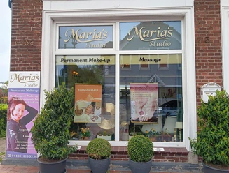 Marias-Studio-Aussenansicht.jpg Backsteinfassade von Marias Studio. Die Schaufenster bewerben Massage und Permanent Make-up.