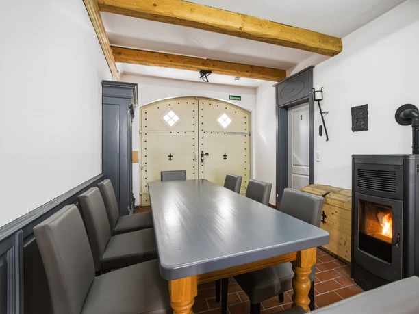 Altstadt Pension Aufenthaltsraum Ein Raum mit einem grauen Tisch in der Mitte, Stühlen und einem Ofen