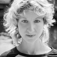 Ann Esswein Portrait of a young person with curly hair and a calm look in black and white.