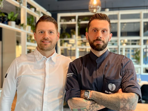 Cornelius Speinle und Gio Murgia in der Küstenperle in Büsum Zwei Männer in Kochjacke in einem Restaurant.