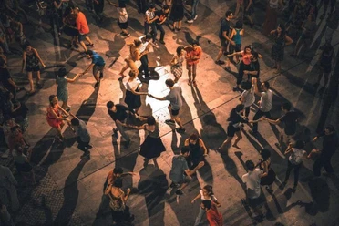 Salsa-Party (c) Franz.jpg In einem Veranstaltungssaal tanzen viele Menschen Salsa auf Holzparkett.