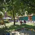 Café Honeck Café Honeck im Grünen mit Sitzgelegenheiten und Spielplatz, geeignet für Familienausflüge.