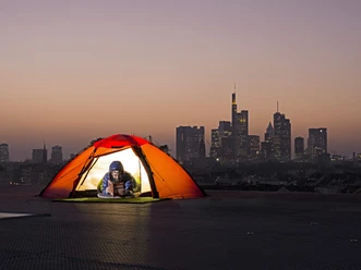 25hours Hotel The Trip - Camping Tent on rooftop overlooking Frankfurt skyline at dusk