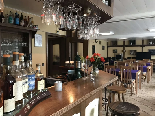 hotel-amjakobsweg-gastraum Holztheke mit Gastraum im Hintergrund