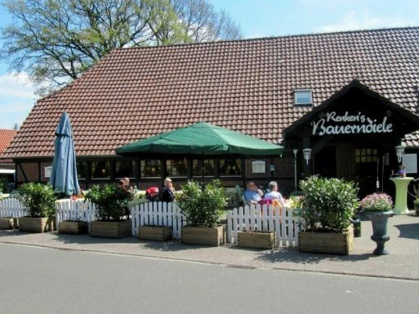 Renkens Das Bild zeigt ein gemütliches Café mit roten Ziegeldach, umgeben von Pflanzen in Holzkübeln.