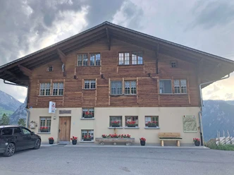Restaurant Springenboden vue extérieure Façade du bâtiment du restaurant, des géraniums rouges sont placés devant les fenêtres