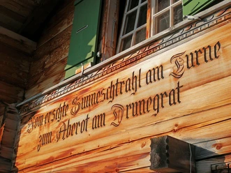 House facade Sennhütte Menigwald with inscription Wooden facade of the alpine hut with carved inscription