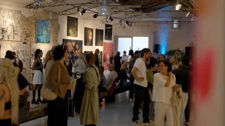 1000freund Gallery People look at paintings at a well-attended exhibition in an open gallery space