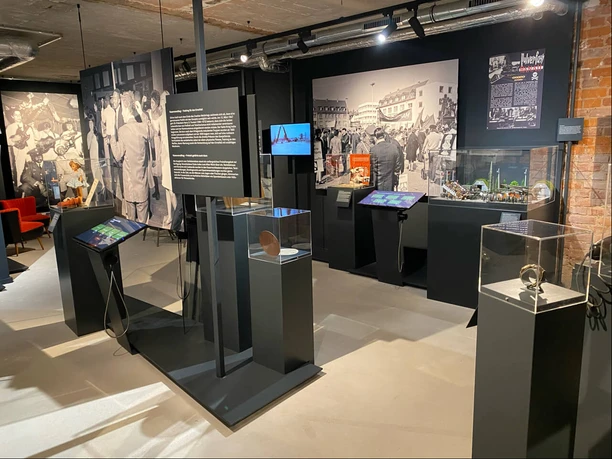 Museum room with historic photos and objects