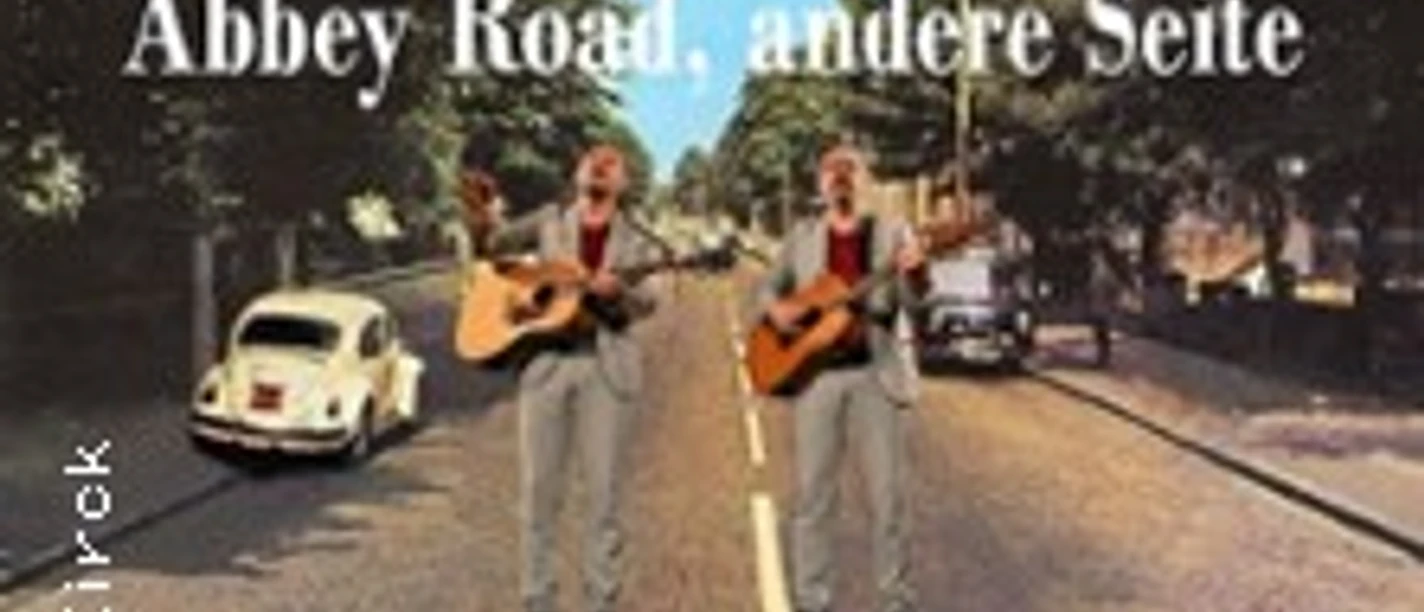 Plakat zu Jan King: zwei Musiker mit Gitarren auf einem Zebrastreifen im Abbey-Road-Stil