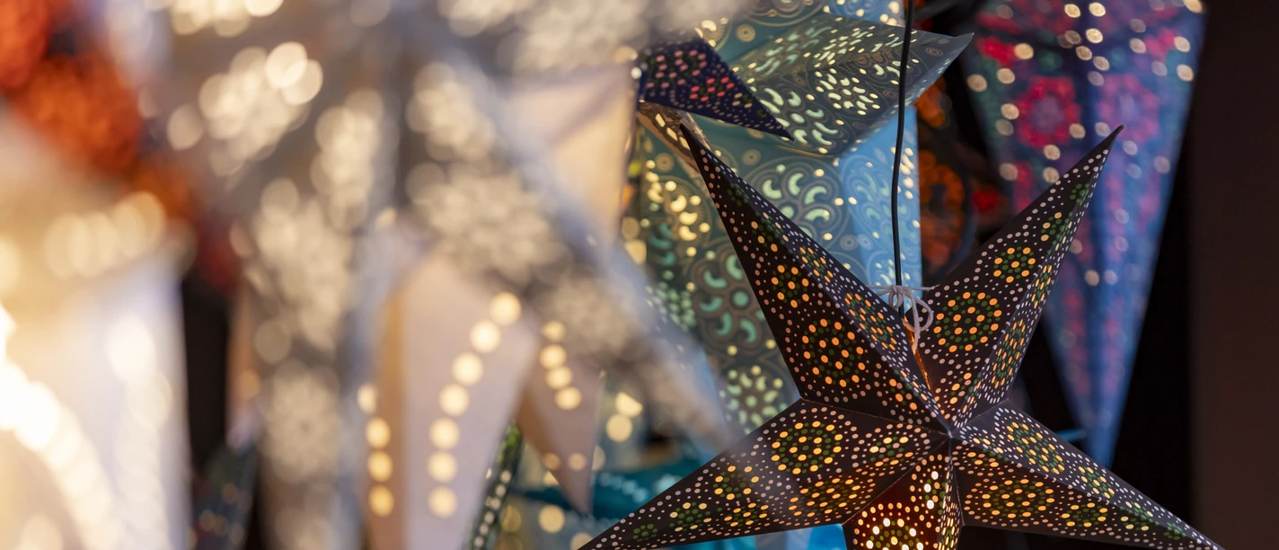 Colorful, bright paper stars at a Christmas market booth