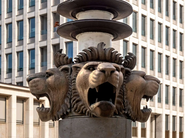 Gerling Quarter Bronze lion heads on a column in front of the facade of the Gerling Quarter in Cologne