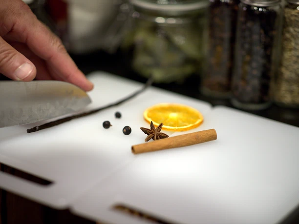 Botanicals for homemade gin: cinnamon, star anise, orange slice, and juniper berries.