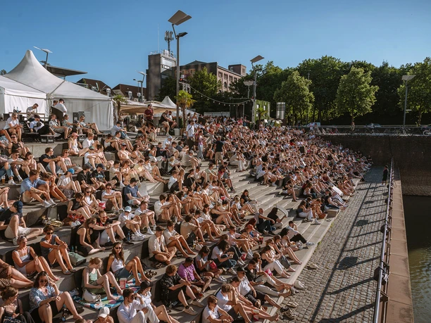 Open-Air Movie Theater at Rheinauhafen Audience on the Rhine Steps at the open-air movie theater in Cologne's Rheinauhafen on a sunny evening