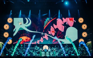 Disney in Concert – The Anniversary Tour A Disney in Concert stage production featuring an orchestra, singers, a light show, and ocean scenes