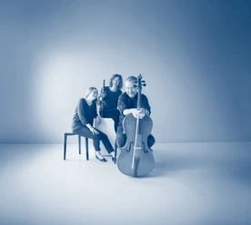 Trio Laflamme Three smiling musicians playing the transverse flute and cello in blue studio lighting