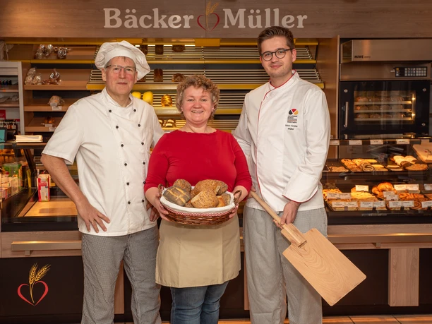 Bäckerei Müller Drei Mitarbeitende von Bäcker Müller stehen mit Brotkorb vor der Ladentheke.