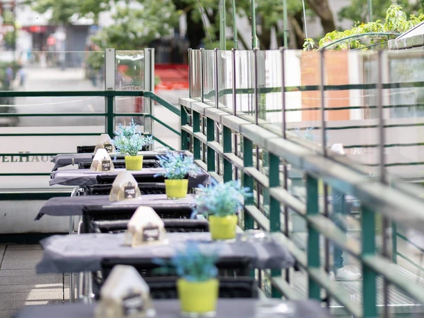 Stapelhaus The Stapelhaus's outdoor terrace with Sion-Kölsch umbrellas and set tables