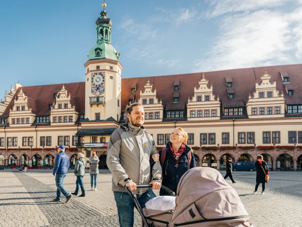 Altes Rathaus - Leipzig mit Kindern Ein glückliches Paar schiebt einen Kinderwagen über den Leipziger Marktplatz, im Hintergrund ist das Alte Rathaus zu sehen
