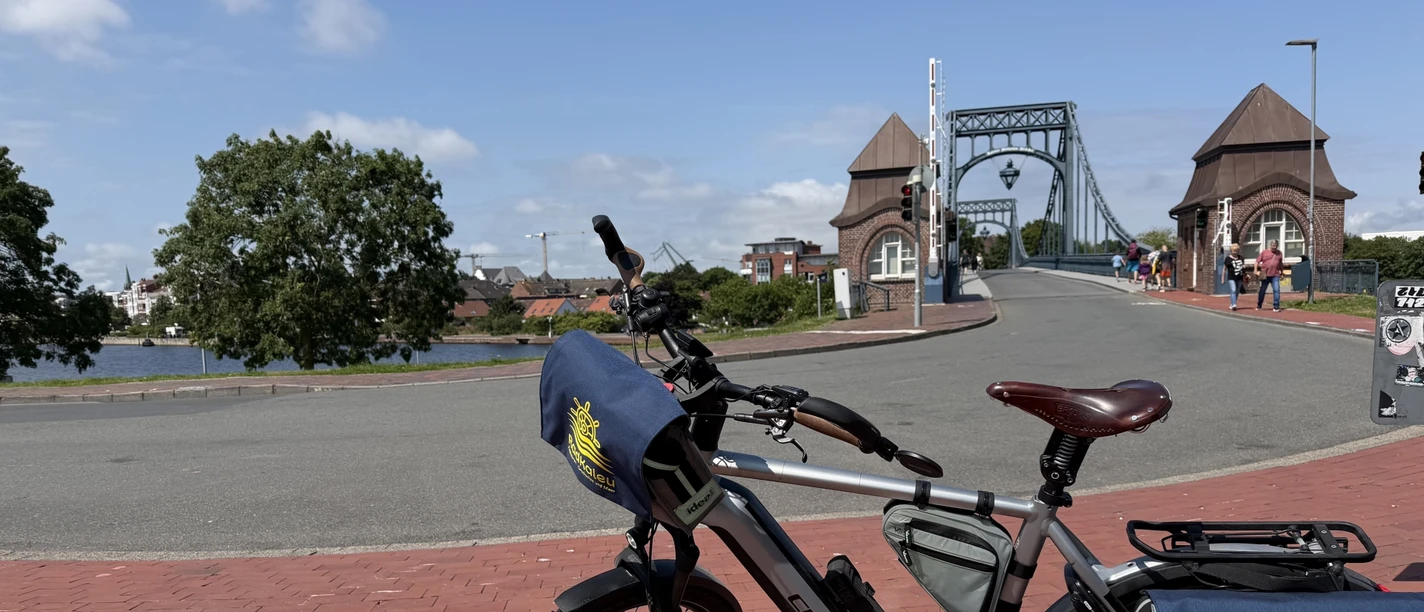 radtour-hooksiel-wilhelmshaven-kaiser-wilhelm-bruecke.jpg Alternativtext / Alt-Text: RadKaleu-Fahrrad vor der Kaiser-Wilhelm-Brücke in Wilhelmshaven