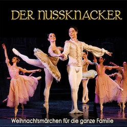 Ballettszene aus Der Nussknacker mit Tänzerinnen und Tänzer in festlichen Kostümen.
