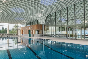 PiORAMA Penzberg_Schwimmerbecken mit Zylinderdecke Schwimmerbecken im PiORAMA mit Glasfront, Liegen und markanter Zylinderdecke