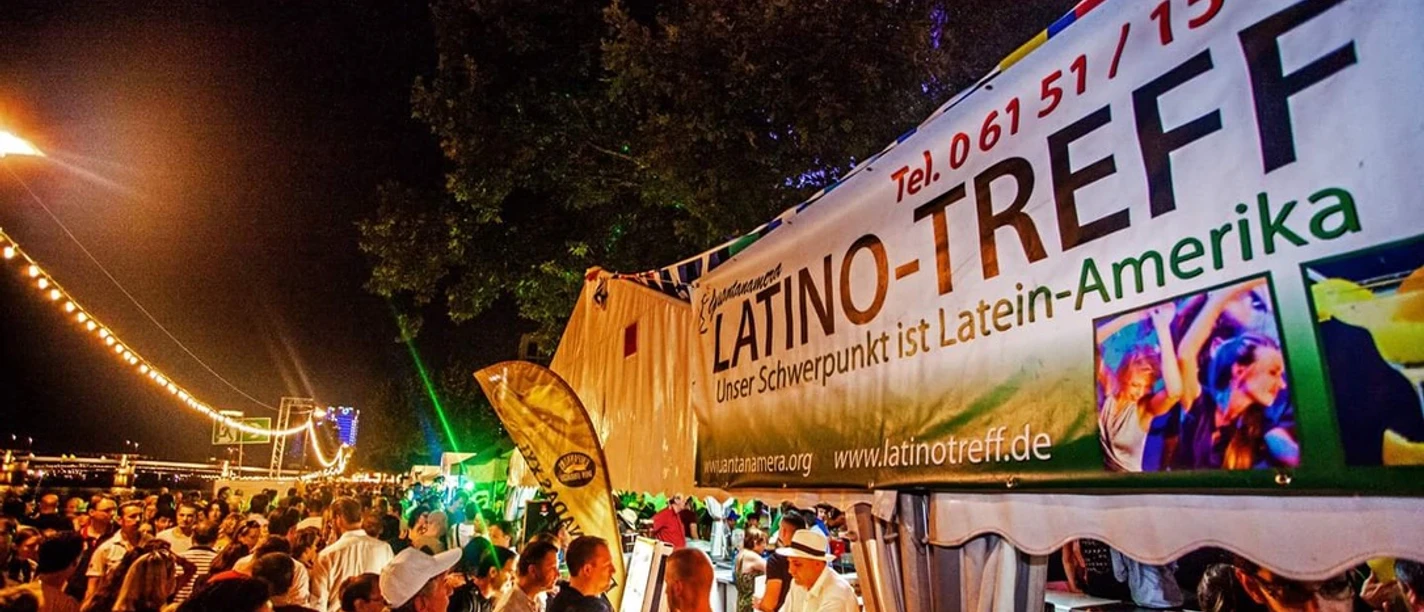 Fiesta Latina - Crowd People at Latino stall at night festival by the river