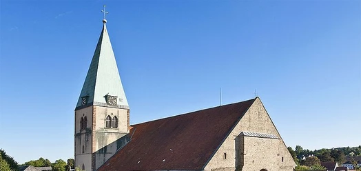 Kirche St. Marien in Lemgo mit Turm, rotem Dach und blauem Himmel