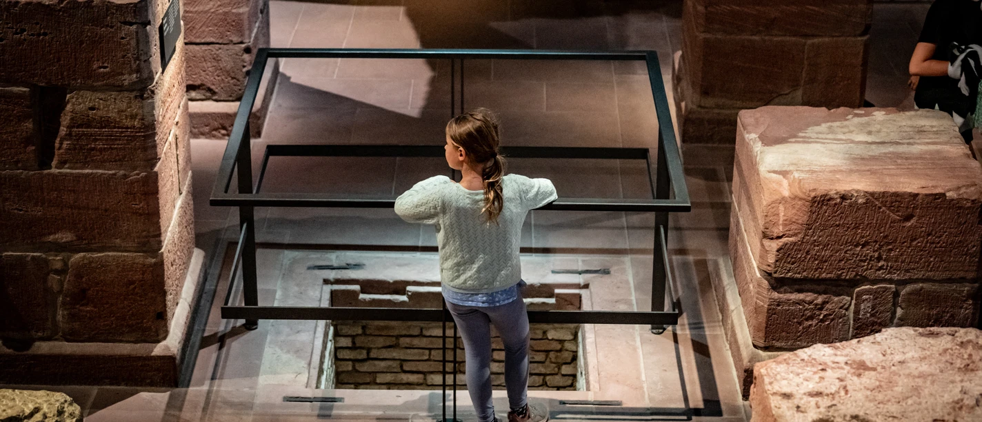 Museum Judengasse - Kinder Sommer Workshop Kind blickt in archäologische Ausgrabung im Museum