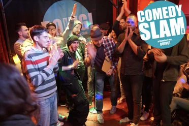 BOING! Comedy Slam: The Jackpot Show Cheering comedians and the audience at the BOING! Comedy Slam on a colorfully lit stage