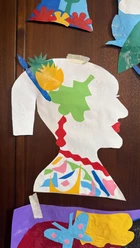 Colourful paper collage of woman’s profile on wall