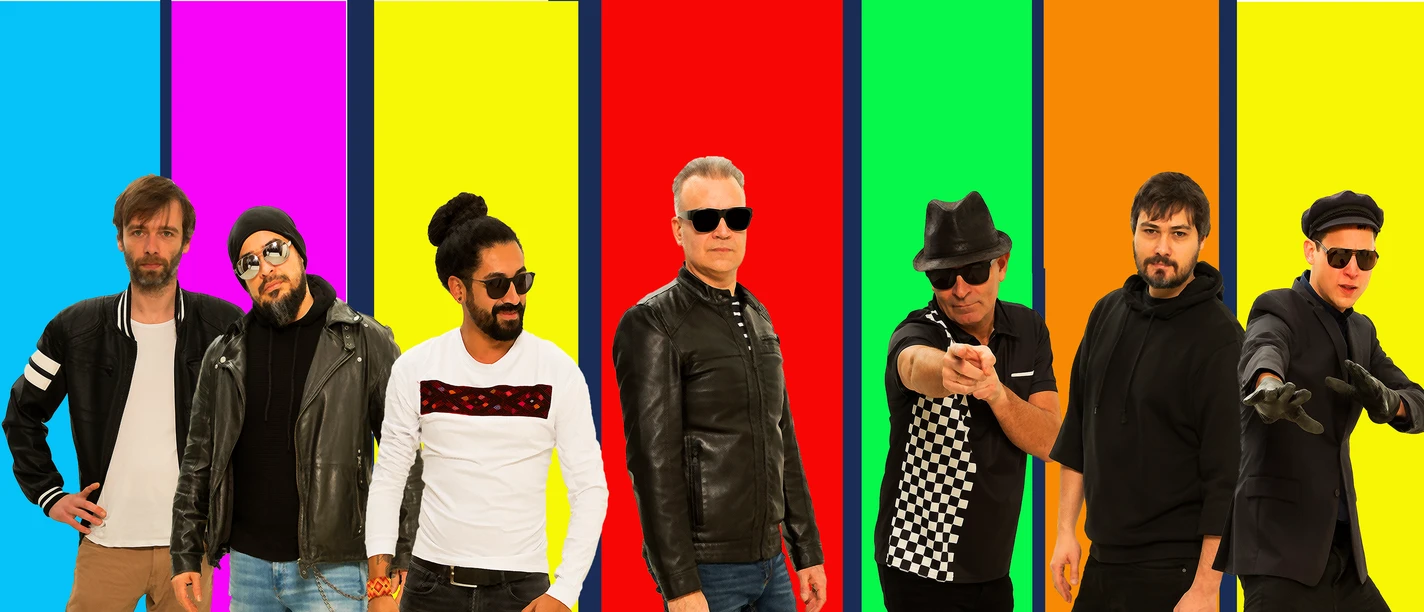 Six men in front of colourful striped background
