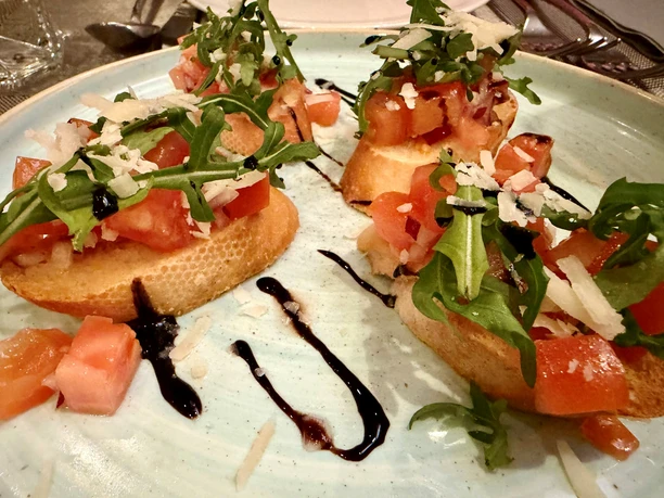Bread with Chunks of Tomato, Arugula, and Parmesan
