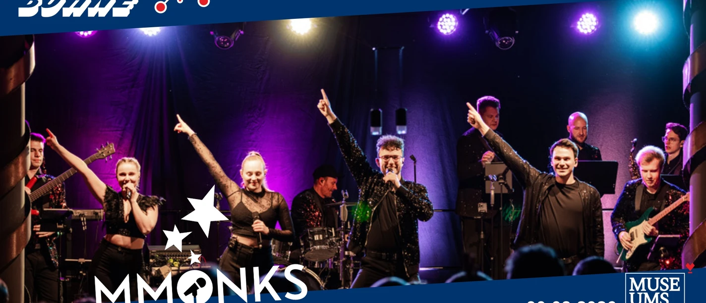 Die MMONKS-Band performt auf einer bunt beleuchteten Bühne