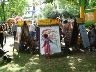 Children are painting at an easel.