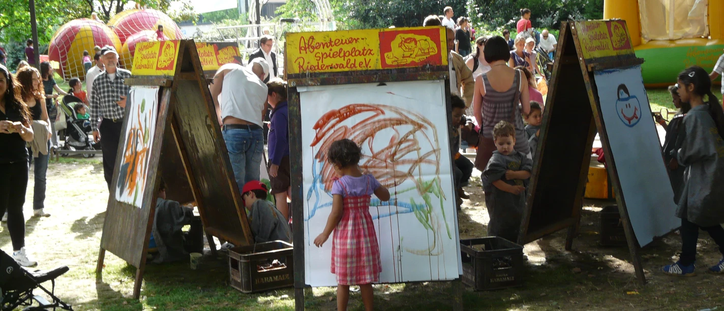Children are painting at an easel.