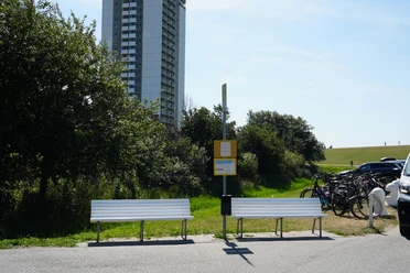 Eine Haltestelle vor einem Hochhaus
