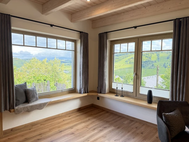 Aussichtsreich Willingen, Aussicht Helle Sitzecke mit großen Fenstern und weitem Blick über grüne Hügel bei Willingen
