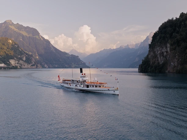 Historisches Dampfschiff auf dem Vierwaldstättersee bei Abendlicht.